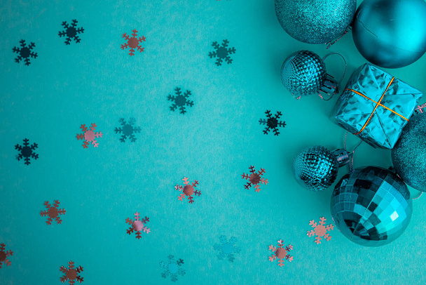 Christmas holidays composition, top view blue-aquamarine Christmas decorations on a green-blue background with copy space for text. Flat lay. Winter, postcard template. - Photo, Image