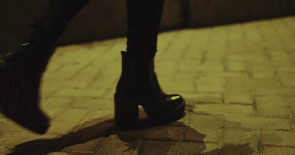 Woman legs going night on modern city road. Fashion shoes walking on street. - Foto, Imagen