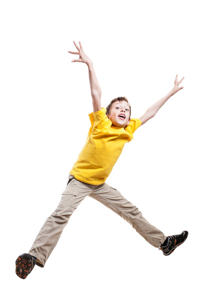 Funny child in yellow t-shirt jumping in excitement with funny expression - Φωτογραφία, εικόνα