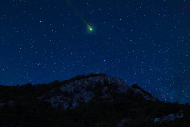 Νυχτερινή σκηνή με έναν κομήτη, έναν αστεροειδή, έναν μετεωρίτη να πετάει στον ουρανό. Νυχτερινό τοπίο. - Φωτογραφία, εικόνα
