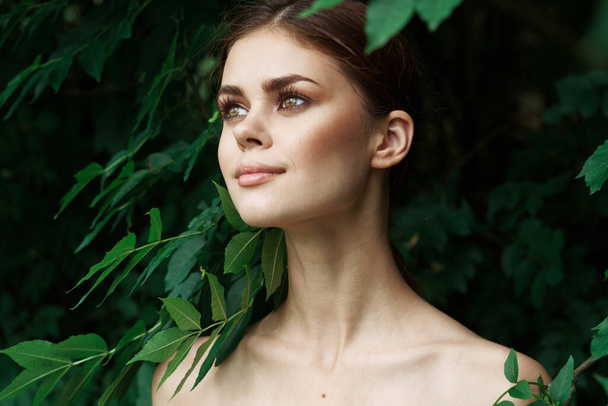 beautiful woman Cosmetology nature green leaves glamor model - Foto, imagen
