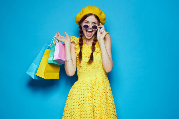 pretty woman with multicolored bags posing studio model - Photo, image