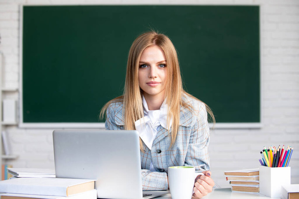 Portrait of cute attractive young woman student in university or high school college. Webinar e-learning at school, distance education. - Фото, зображення