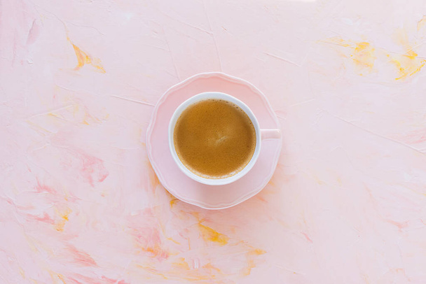 Cup of espresso coffee on pink background - Фото, зображення