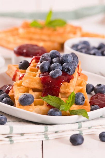 Waffles with blueberries and jam.  - Valokuva, kuva