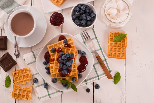 Waffles with blueberries and jam.  - Zdjęcie, obraz