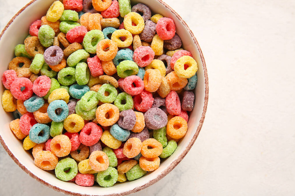 Bowl of colorful cereal rings on light background - Photo, Image