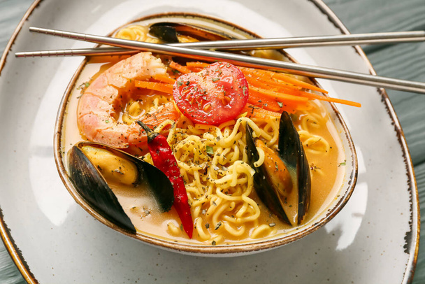 Bowl of spicy Thai soup on table, closeup - Zdjęcie, obraz