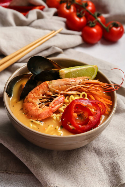Bowl of spicy Thai soup on table - Photo, Image