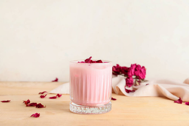 Glass of tasty rose latte on table - Zdjęcie, obraz