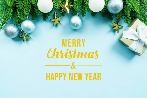 Vánoční dárek a borovice s vánoční výzdobou na modrém pozadí - Fotografie, Obrázek