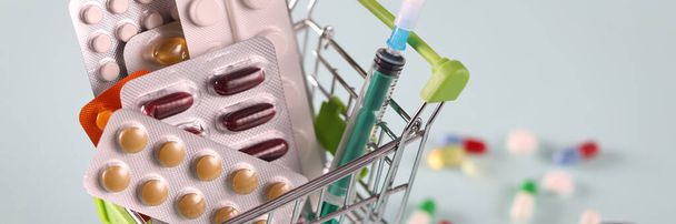 Assorted medications and syringe in basket closeup - Photo, Image