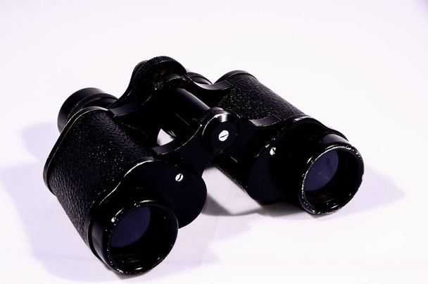 Vintage Used Black Binoculars on white background - Фото, изображение