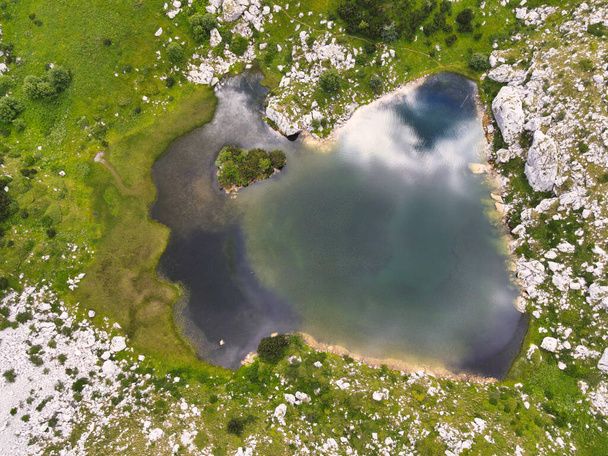 An aerial view of a small lake in the mountai - Foto, imagen