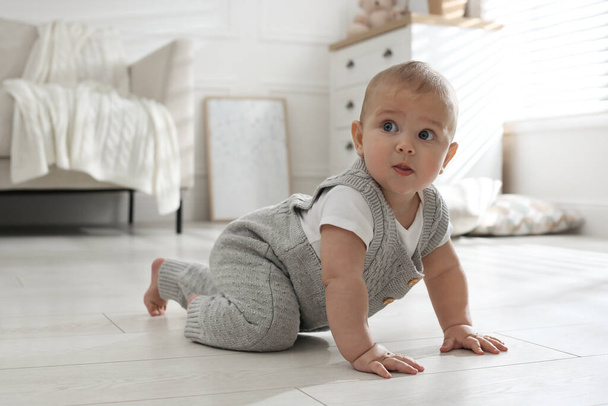 Cute baby crawling on floor at home - Fotografie, Obrázek