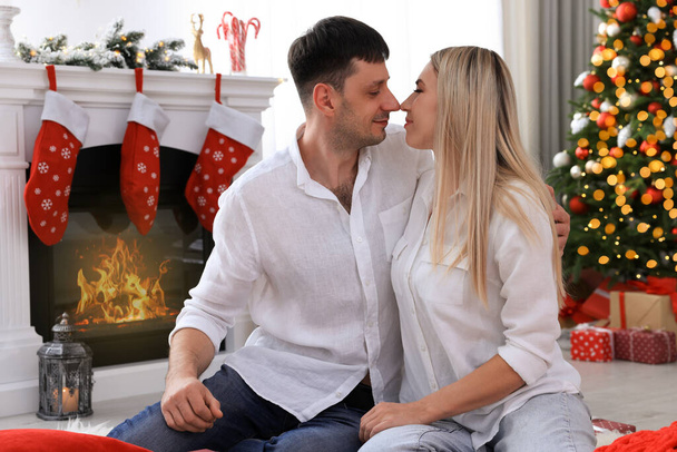Lovely couple in room decorated for Christmas - Photo, Image