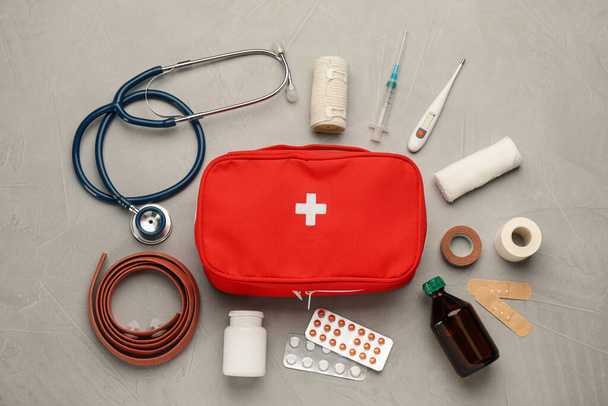 First aid kit on grey table, flat lay - Foto, Bild