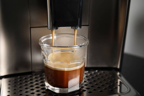 Espresso machine pouring coffee into glass, closeup - Fotoğraf, Görsel