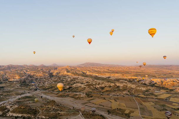 Flying hot air balloon on the top of white mountains in Cappadocia, Turkey - 写真・画像