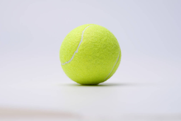 Heldere limoen tennisbal op witte achtergrond closeup - Foto, afbeelding
