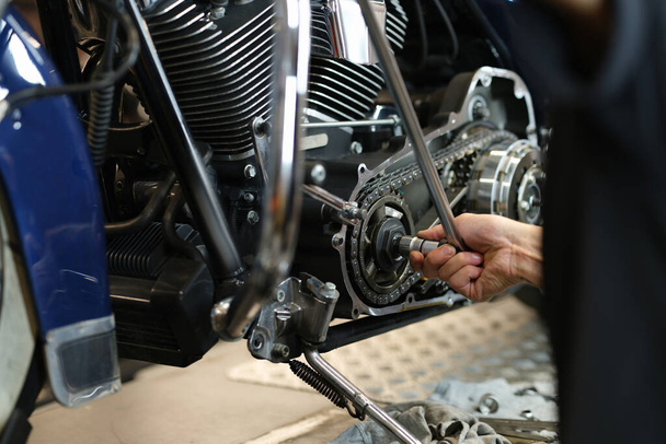 Dismantling a motorcycle engine in service center closeup - Photo, Image