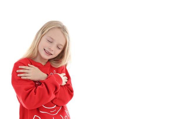 Little girl in Christmas sweater isolated on white background - Fotografie, Obrázek