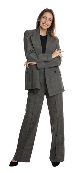 Full length portrait of beautiful young woman in fashionable suit on white background. Business attire - Foto, Bild