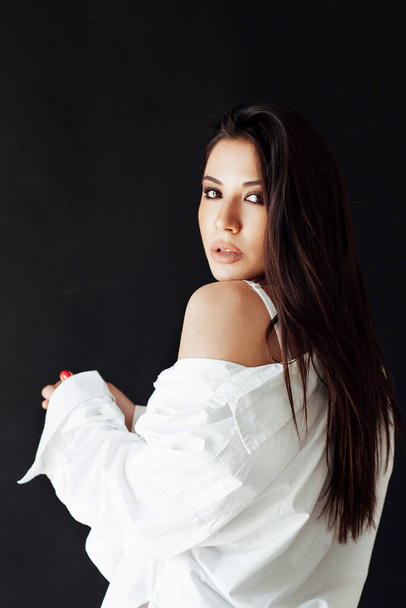 beautiful oriental brunette woman in a white shirt - Photo, image