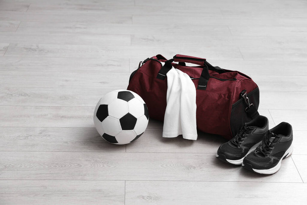 Sports bag with training stuff and equipment on white floor - Fotoğraf, Görsel