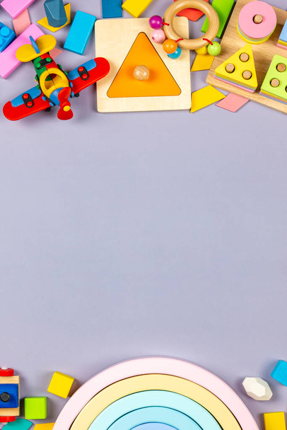 Baby kids toys frame. Colorful educational wooden plastic toys for children on gray background. Top view - Photo, image