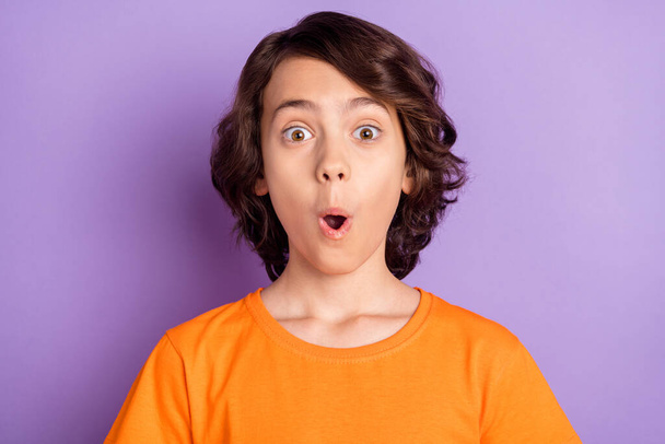 Portrait of attractive amazed brown-haired boy schoolkid news reaction pout lips isolated over violet purple color background - Фото, изображение