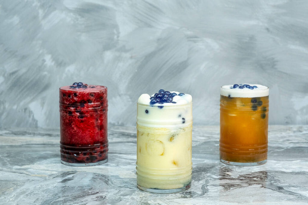 Cold drink in various flavors on a marble floor - Foto, Bild