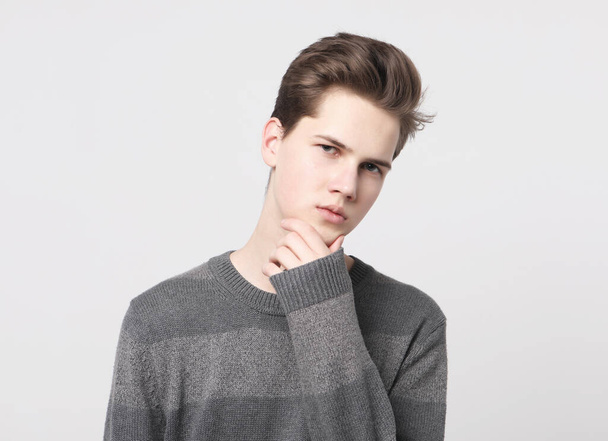young handsome teenage hipster guy posing against white background isolated, lifestyle people concept - Foto, Imagem