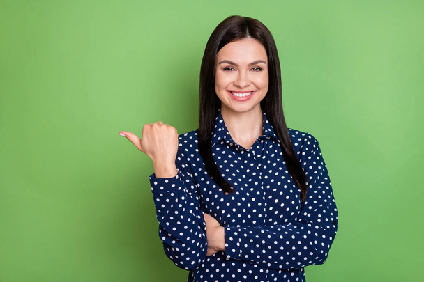Photo of nice brunette hairdo young lady point empty space wear blue shirt isolated on green color background - Фото, зображення