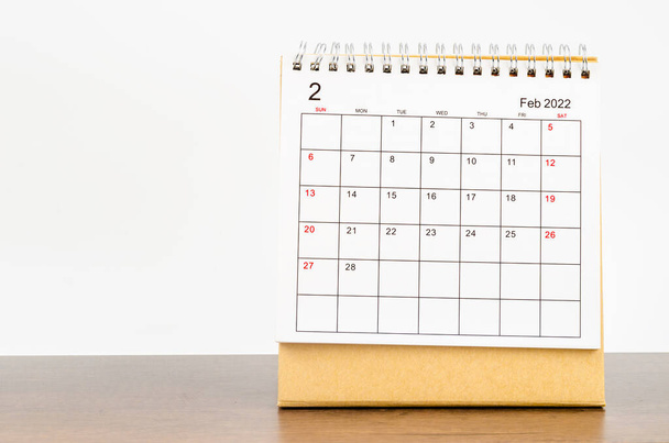 The February 2022 desk calendar on wooden table. - Φωτογραφία, εικόνα