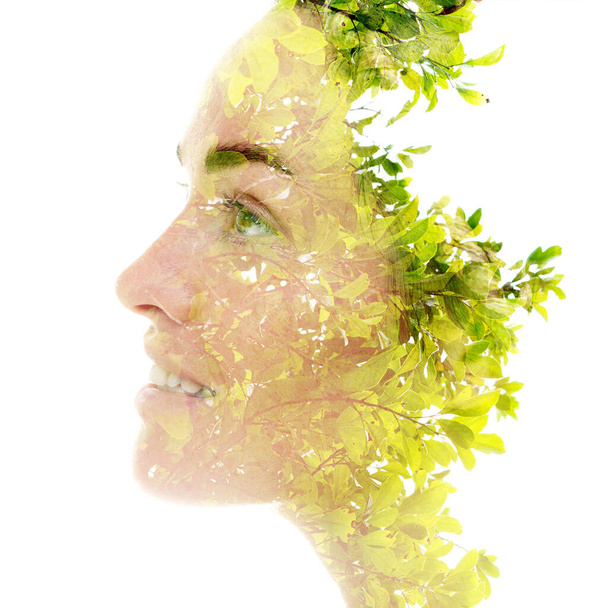A double exposure portrait of a female model combined with an image of a vibrant plant. - Foto, afbeelding