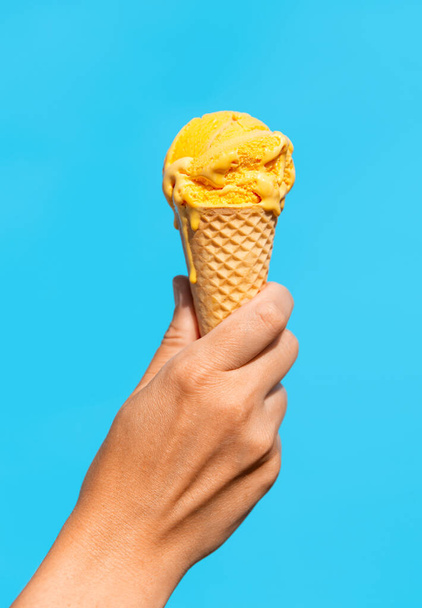 close up of hand holding waffle ice cream cone - Foto, Imagen