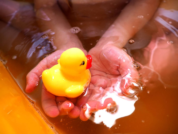 Yellow rubber duck for swimming. Bathing children in the tub. Hygiene of the child. - Photo, Image