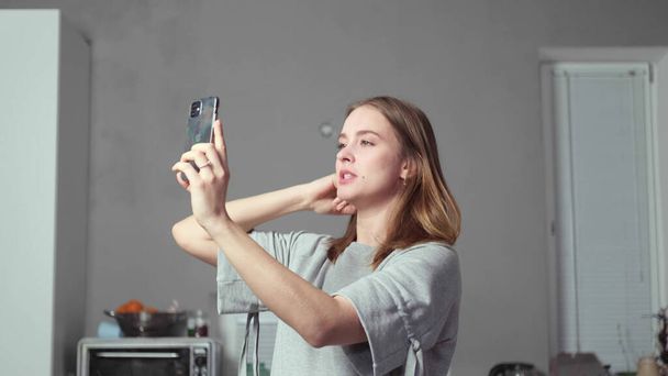 a girl with a phone in her hands takes a selfie - Fotoğraf, Görsel