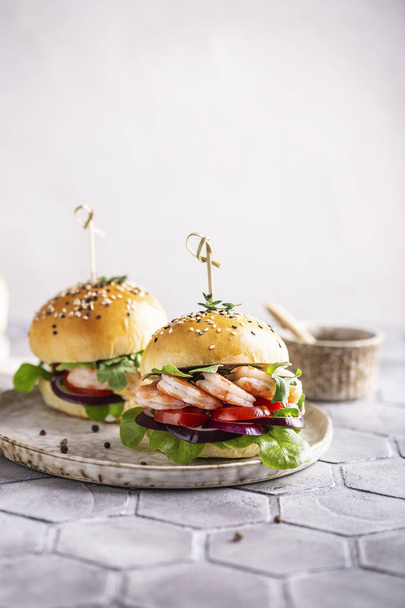 Shrimp burger with vegetables for dinner - 写真・画像