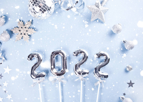 Christmas decoration with silver toys, stars, balls and 2022 numbers. Top view. - Photo, Image