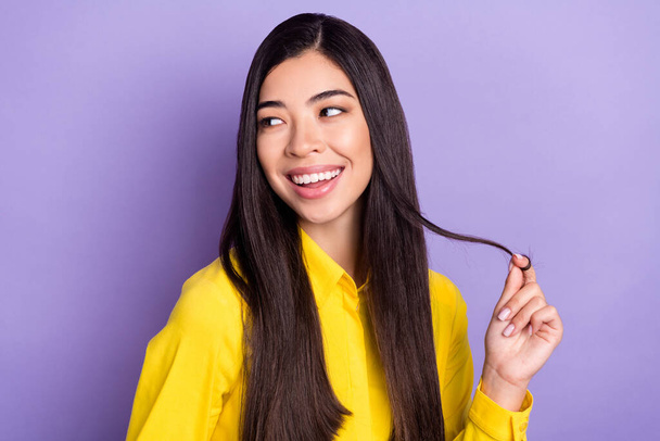 Photo of dreamy positive nice young woman look empty space wear yellow shirt isolated on violet color background - Foto, Imagem