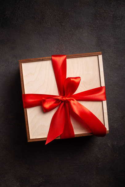 Gift boxes with red ribbon on a black background - Foto, imagen