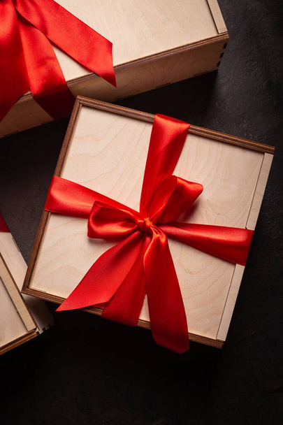 Gift boxes with red ribbon on a black background - Foto, immagini