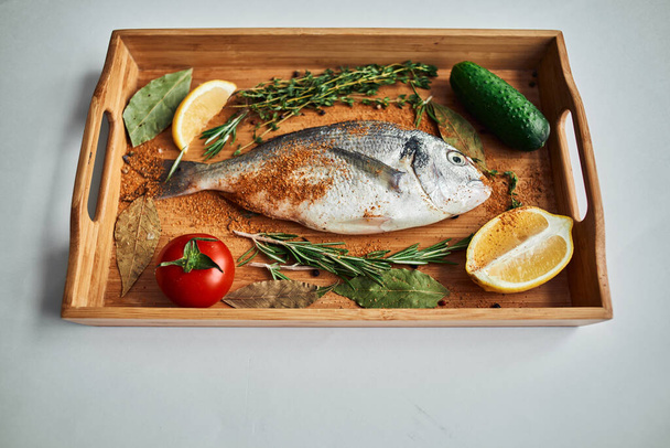 sea fish fresh ingredients lemon on wooden board - Photo, image