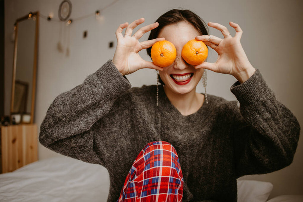 mulher com tangerinas em casa - Foto, Imagem