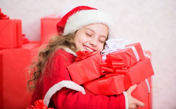 Girl celebrate christmas. Santa bring her gift. Dreams come true. Winter happiness concept. Explore christmas gifts. Unpacking christmas gift. Kid excited about christmas present. Winter miracle - Фото, изображение