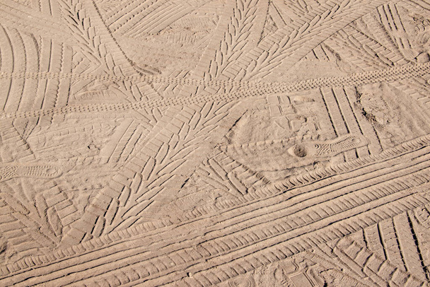 Footprints on the yellow sand on the beach - 写真・画像