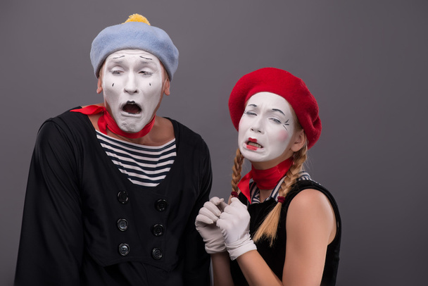 Portrait of sad mime couple crying isolated on grey background - Fotoğraf, Görsel