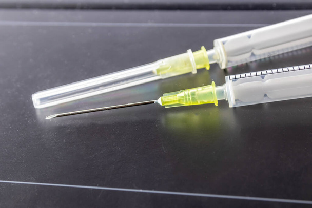 New medical vaccines ready for injection with syringe and vaccine to inject the cure for immunization into ill and weak patients to heal their suffers and illnesses supported corona health care system - Foto, Imagem
